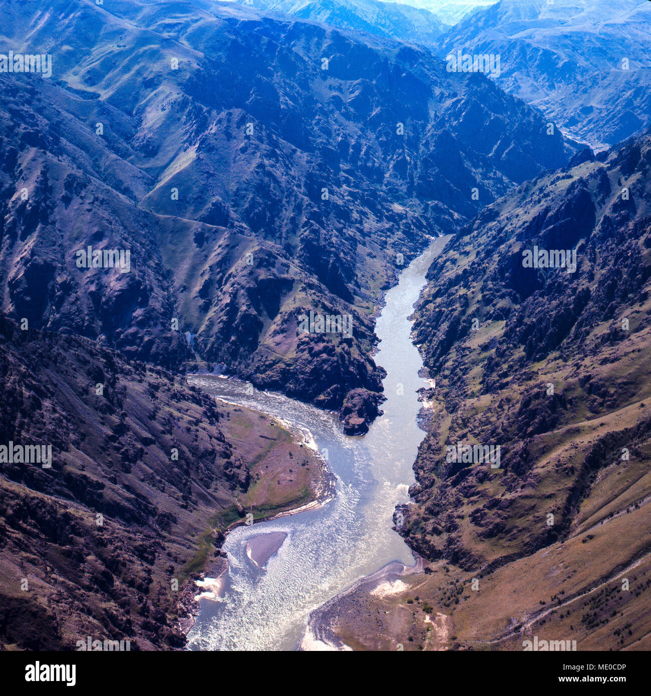 Confluence of Salmon River (L) and Snake River (R) in Hells Canyon, deepest gorge in N. America. Idaho on left, Oregon on right. Photographer Norton l Stock Photo