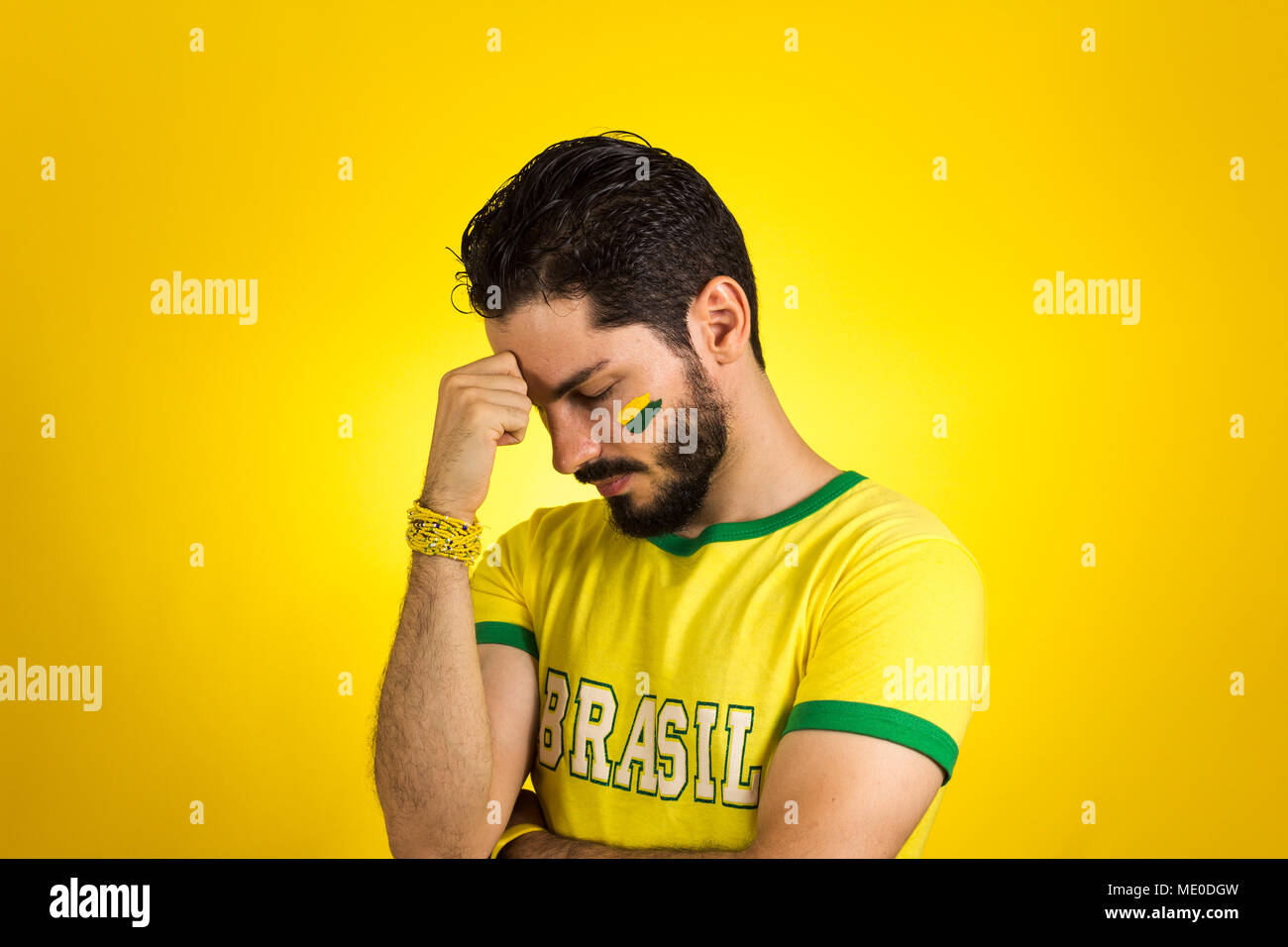 Soccer fan in action emotions depressed, worried. Supporter of Brazil