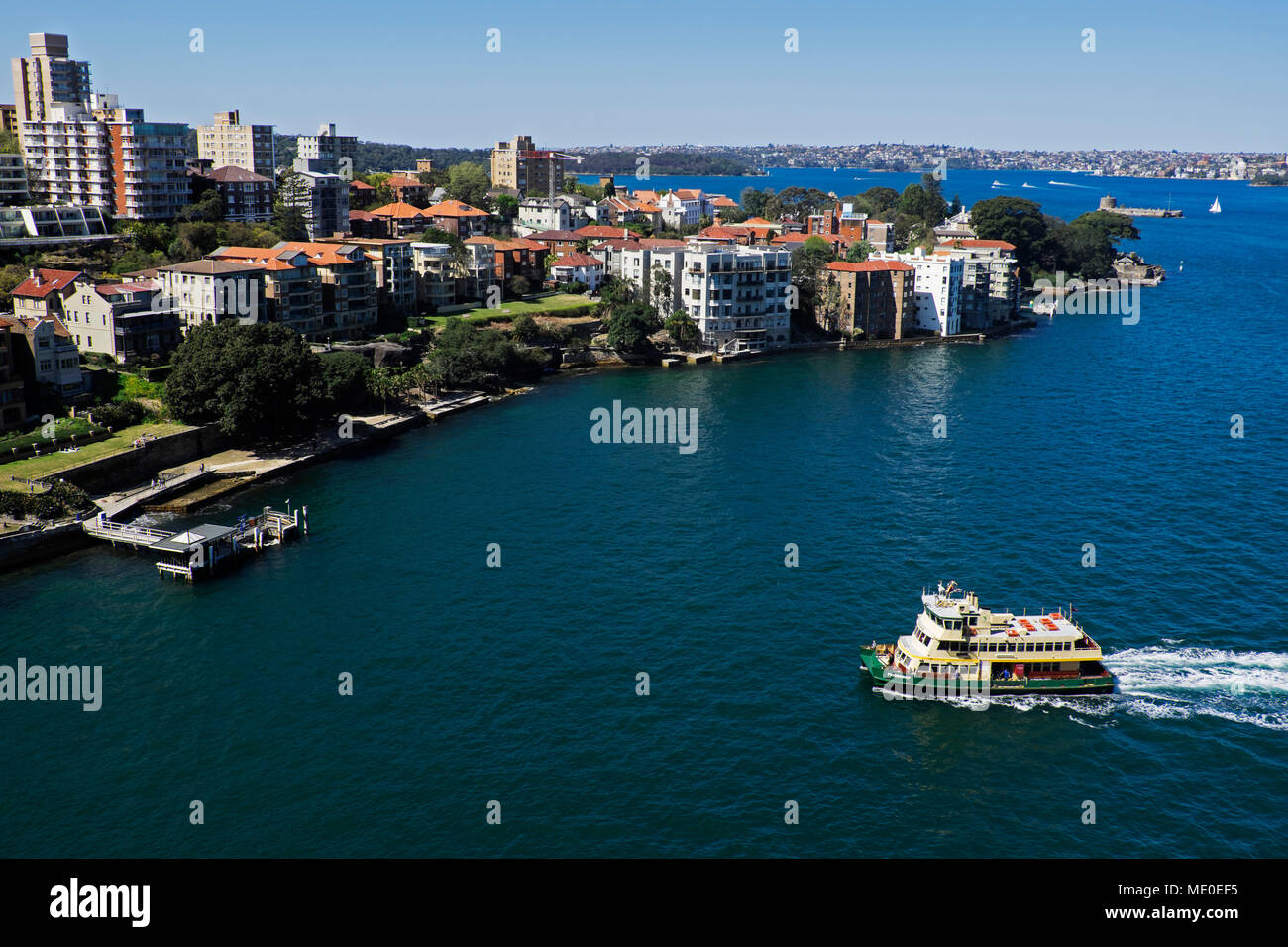 Ferry boat approaching dock in Sydney Harbour on a sunny day in Sydney, Australia Stock Photo