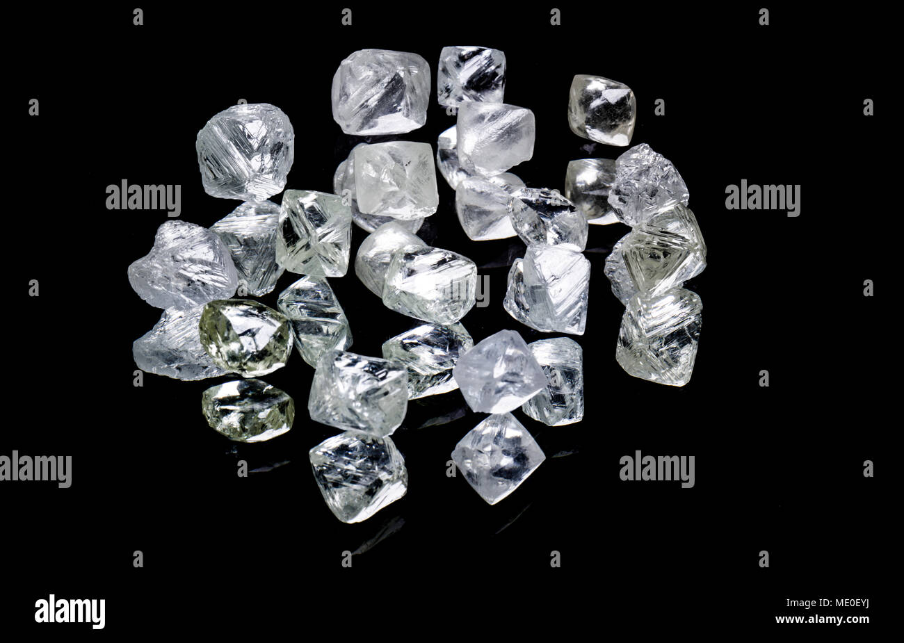 Raw diamonds isolated on black background. Stock Photo