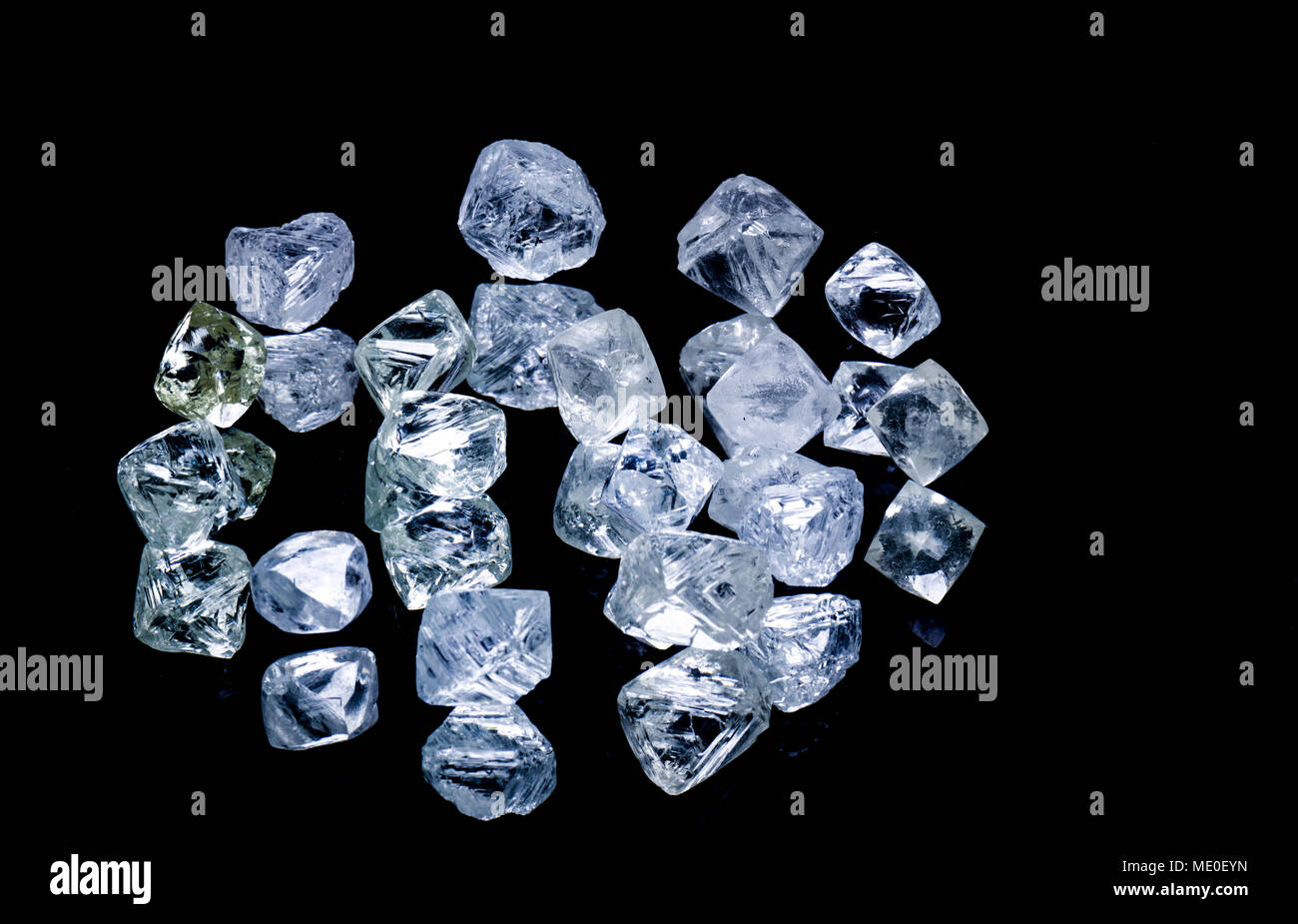 Raw diamonds isolated on black background. Stock Photo