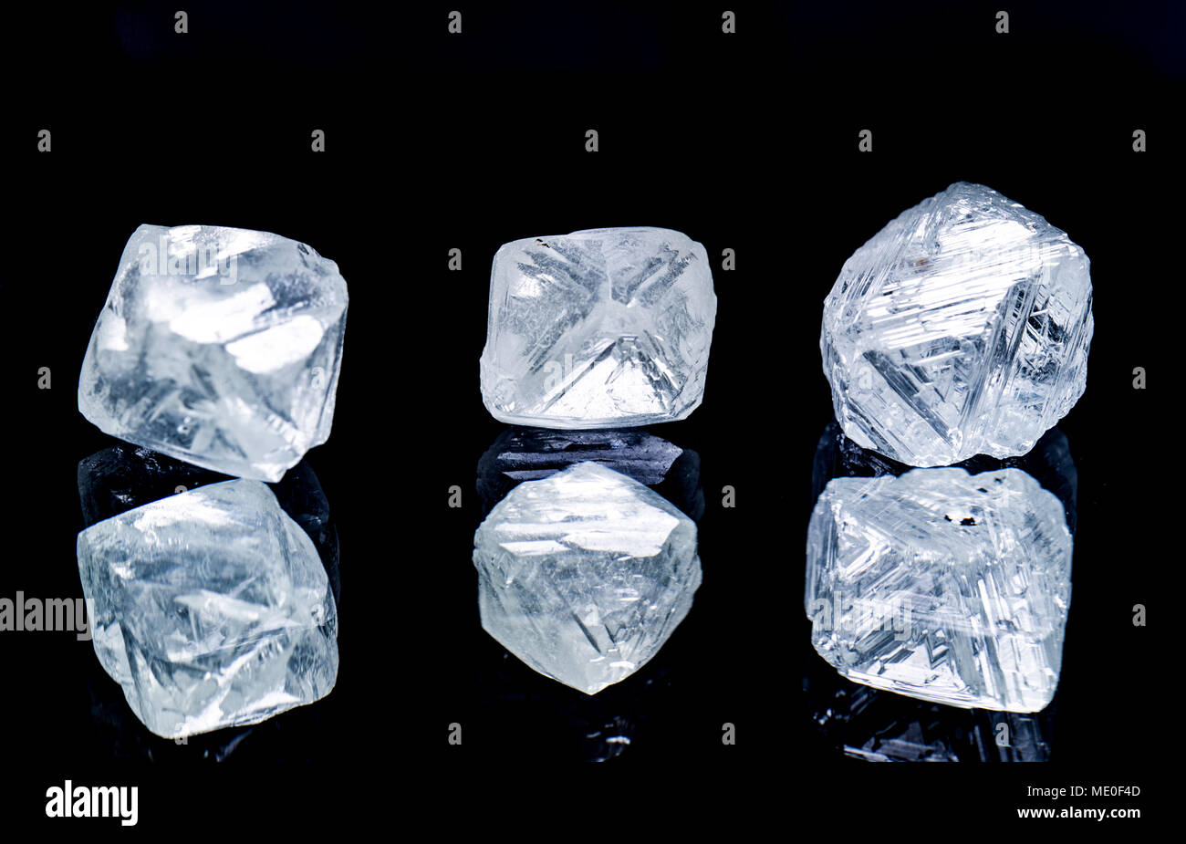 Raw diamonds isolated on black background. Stock Photo