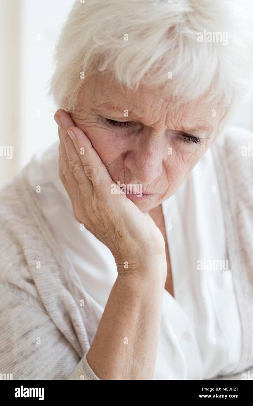 Senior woman with hand on chin. Stock Photo