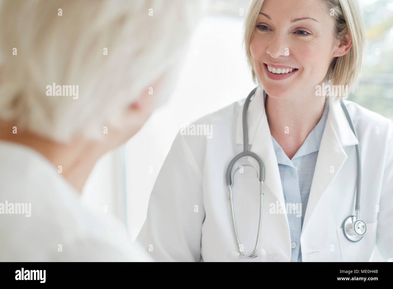 Female doctor smiling towards patient. Stock Photo