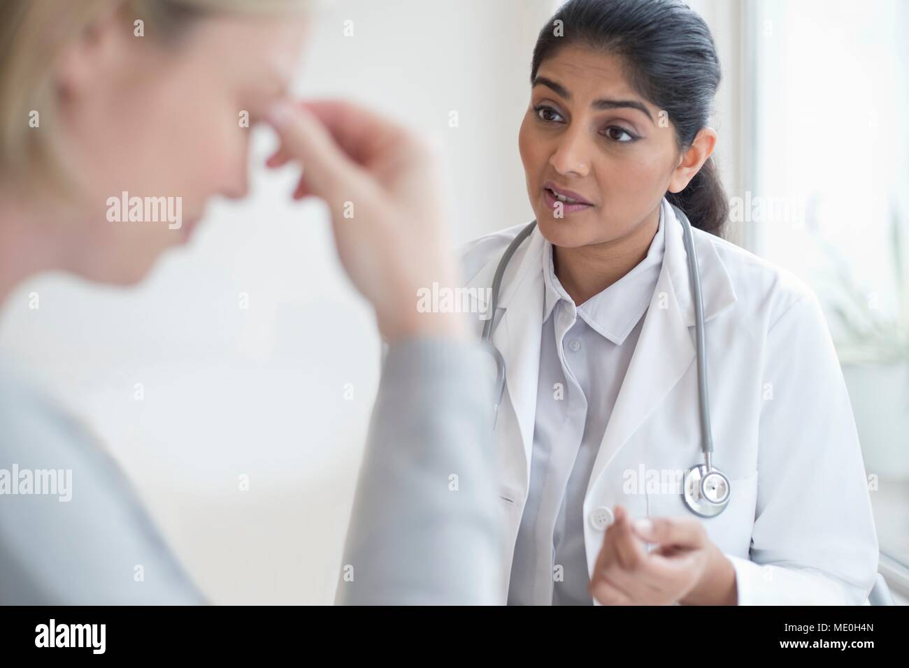 Female doctor talking to patient. Stock Photo