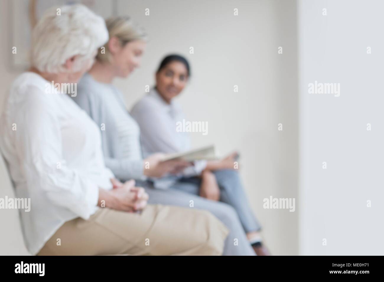 Women sitting in doctor's waiting room. Stock Photo
