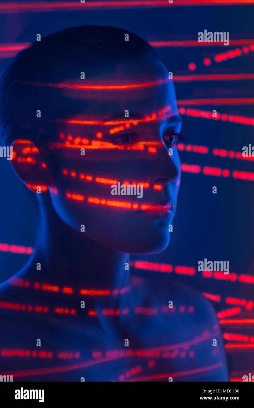 Woman with red lights on face. Stock Photo