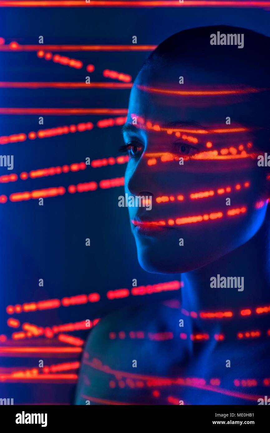 Woman with red lights on face. Stock Photo