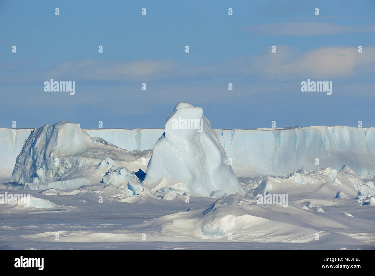 Sunlight reflecting on pack ice and an iceberg on Snow Hill Island at the Weddel Sea, Antarctic Peninsula in Antarctica Stock Photo