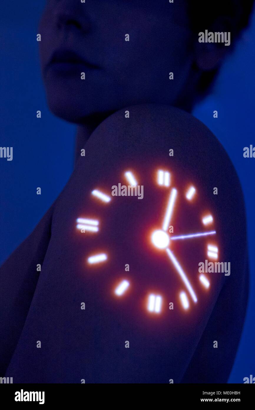 Woman with clock projected on shoulder. Stock Photo