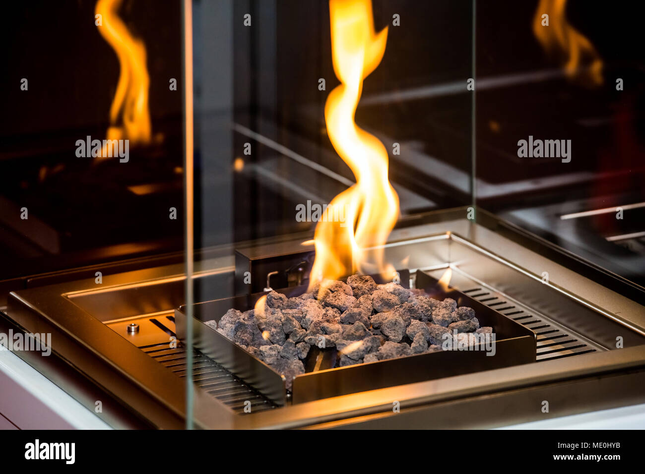 Decorative Artificial Fireplace With White Stones In Room Interior
