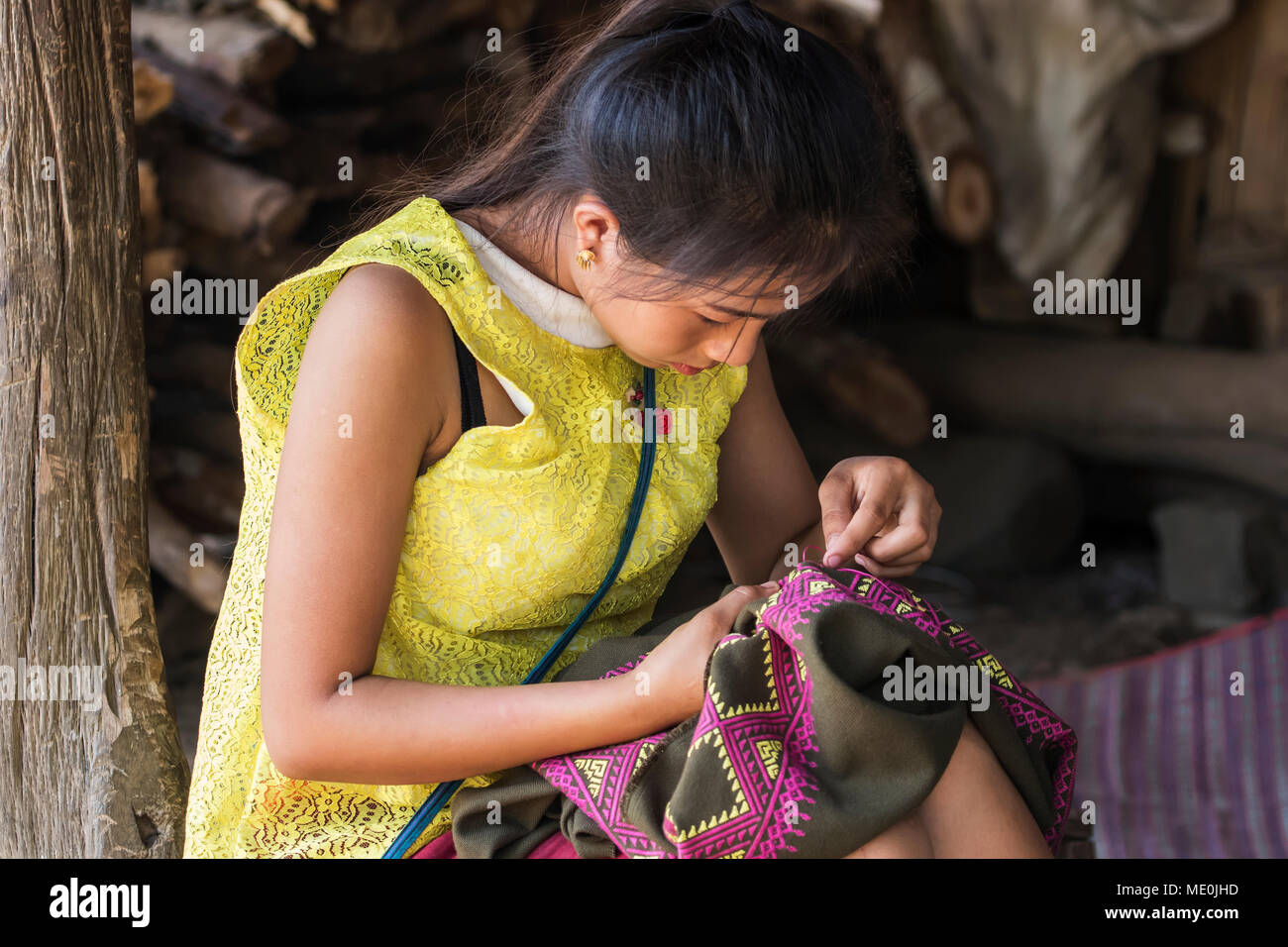 Hmong woman making embroideries, Na Aouan Village; Luang Prabang, Laos Stock Photo