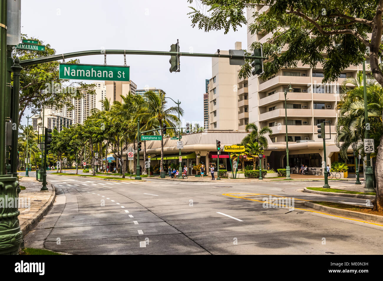 Westward view down Kuhio Avenue at the intersection with Namahana Street in Waikiki; Honolulu, Oahu, Hawaii, United States of America Stock Photo
