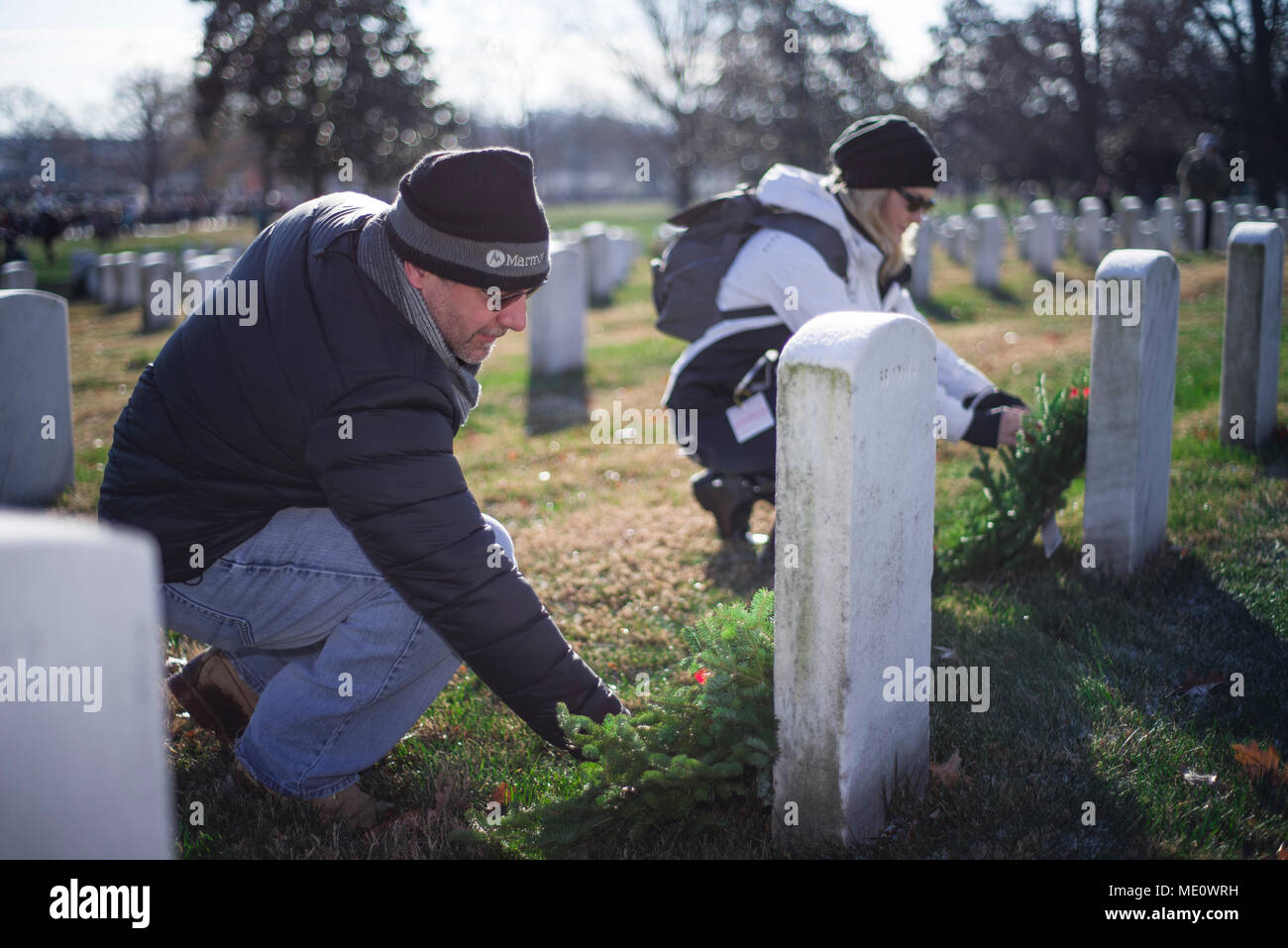 Paul and Stephanie Mamo lay wreaths during Wreaths Across America at  Arlington National Cemetery, Virginia. Participants laid 4,000 wreaths for  fallen service members. U.S. Navy photo by MC2 (SW) Scott Michael Barnes (