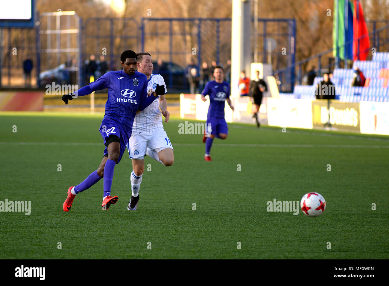 MINSK, BELARUS - APRIL 7, 2018: Soccer players fights for ball during the Belarusian Premier League football match between FC Dynamo Minsk and FC Isloch at the FC Minsk Stadium Stock Photo