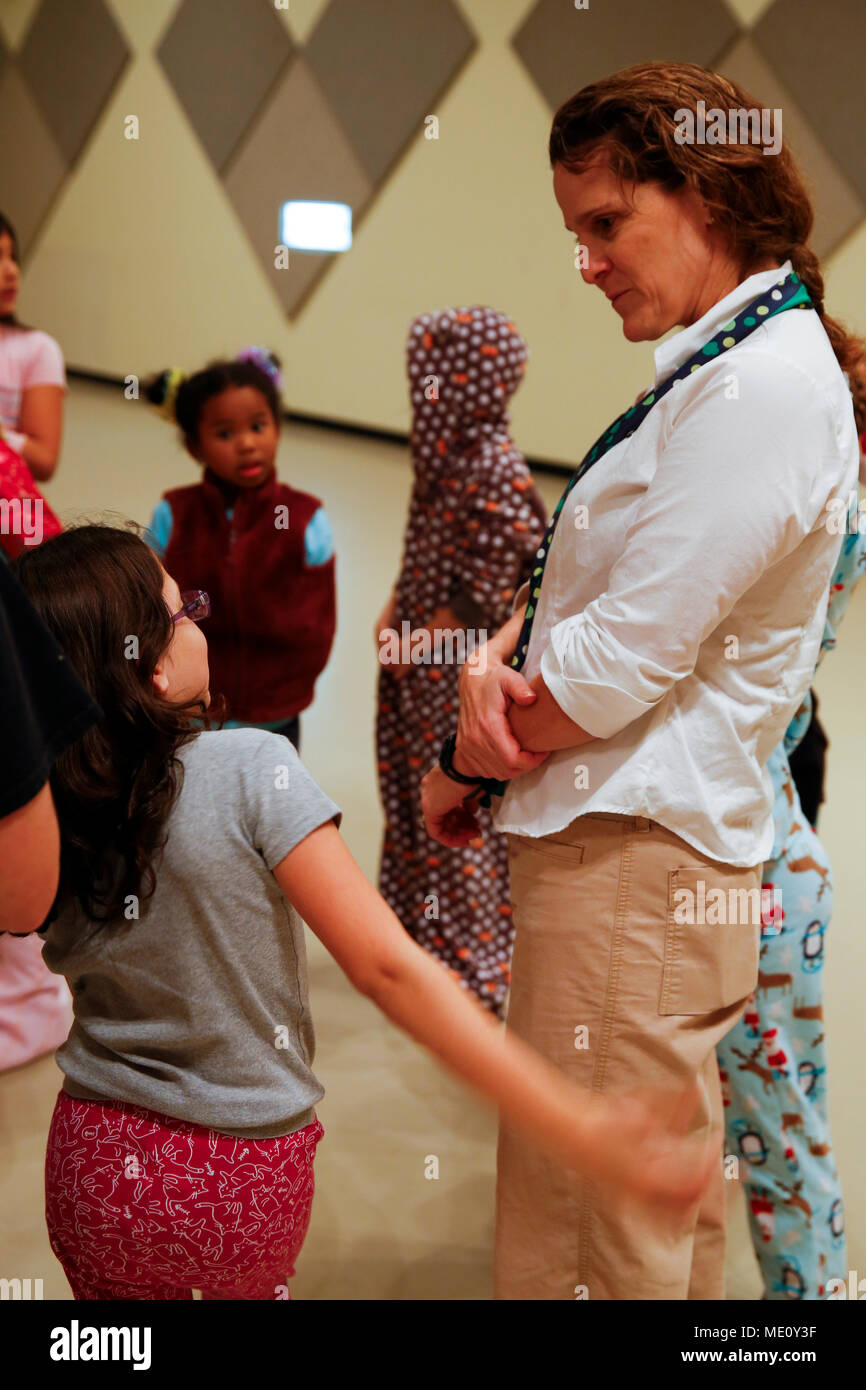 CAMP FOSTER, OKINAWA, Japan – A Foster Girl Scout explains the importance of collecting pajamas during a meeting Dec. 10 at the Community Center aboard Camp Foster, Okinawa, Japan. The Foster Girl Scout Juniors collected donated pajamas to earn the Bronze Award, the highest award a Junior Girl Scout can earn. The donated pajamas are being sent to Sunrin Orphanage, established in 1952 by the III Marine Expeditionary Force toward the end of the Korean War. With help from other Girl Scout troops and the Marine Officer's Spouses Club Okinawa, the Juniors were able to collect 80 pajamas, one for ea Stock Photo