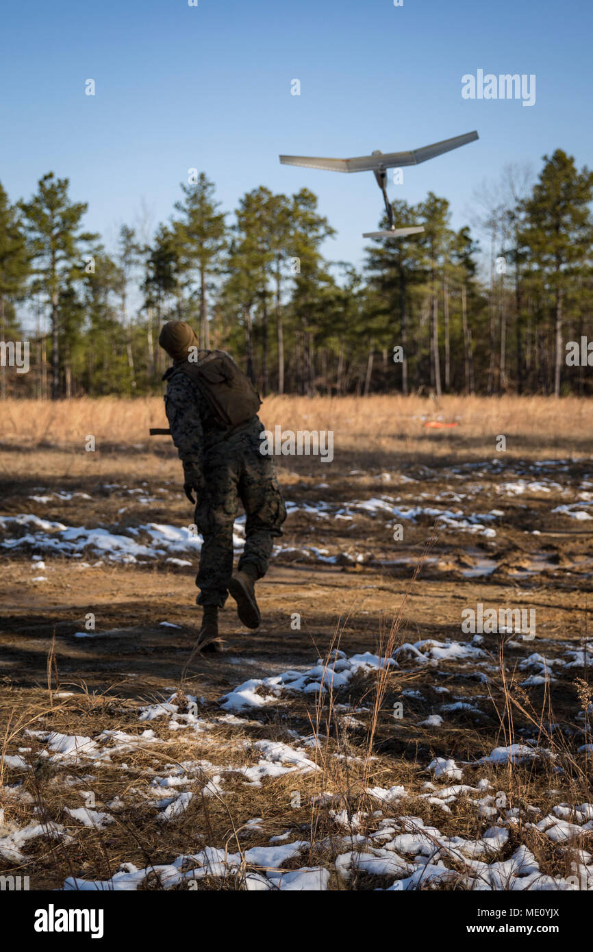 A U.S. Marine with Company E., 2nd Battalion, 8th Marine Regiment, throws a Raven Unmanned Aerial Vehicle to conduct range reconnaissance prior to performing a company level attack range during a Deployment for Training (DFT) on Fort AP Hill, VA., Dec. 11, 2017. The purpose of the DFT is to incorporate all members of the battalion in training squad, platoon, company, and battalion level warfighting skills in order to sustain proficiency in core mission essential tasks for an upcoming deployment. (U.S. Marine Corps photo by Lance Cpl. Timothy J. Lutz) Stock Photo
