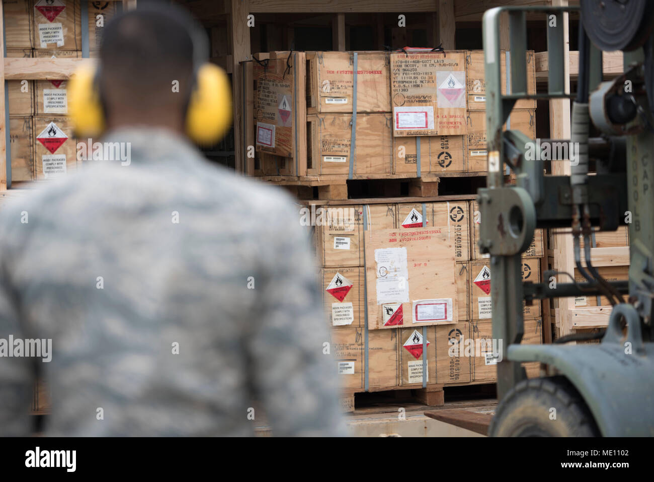 U.S. Air Force Senior Airman Thomas Nollie, 18th Munitions Squadron stockpile management crew chief, watches as munitions are loaded into storage Dec. 19, 2017, at Kadena Air Base, Japan. The 18th MUNS provides the wing and associate units with munitions for more than 6,000 annual sorties. (U.S. Air Force photo by Senior Airman Quay Drawdy) Stock Photo