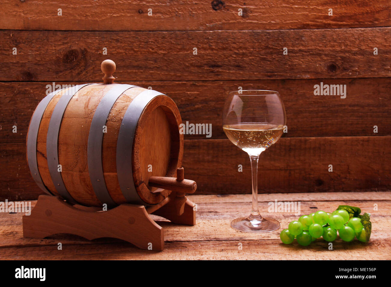 Wine barrel, wine grapes and wine glass Stock Photo