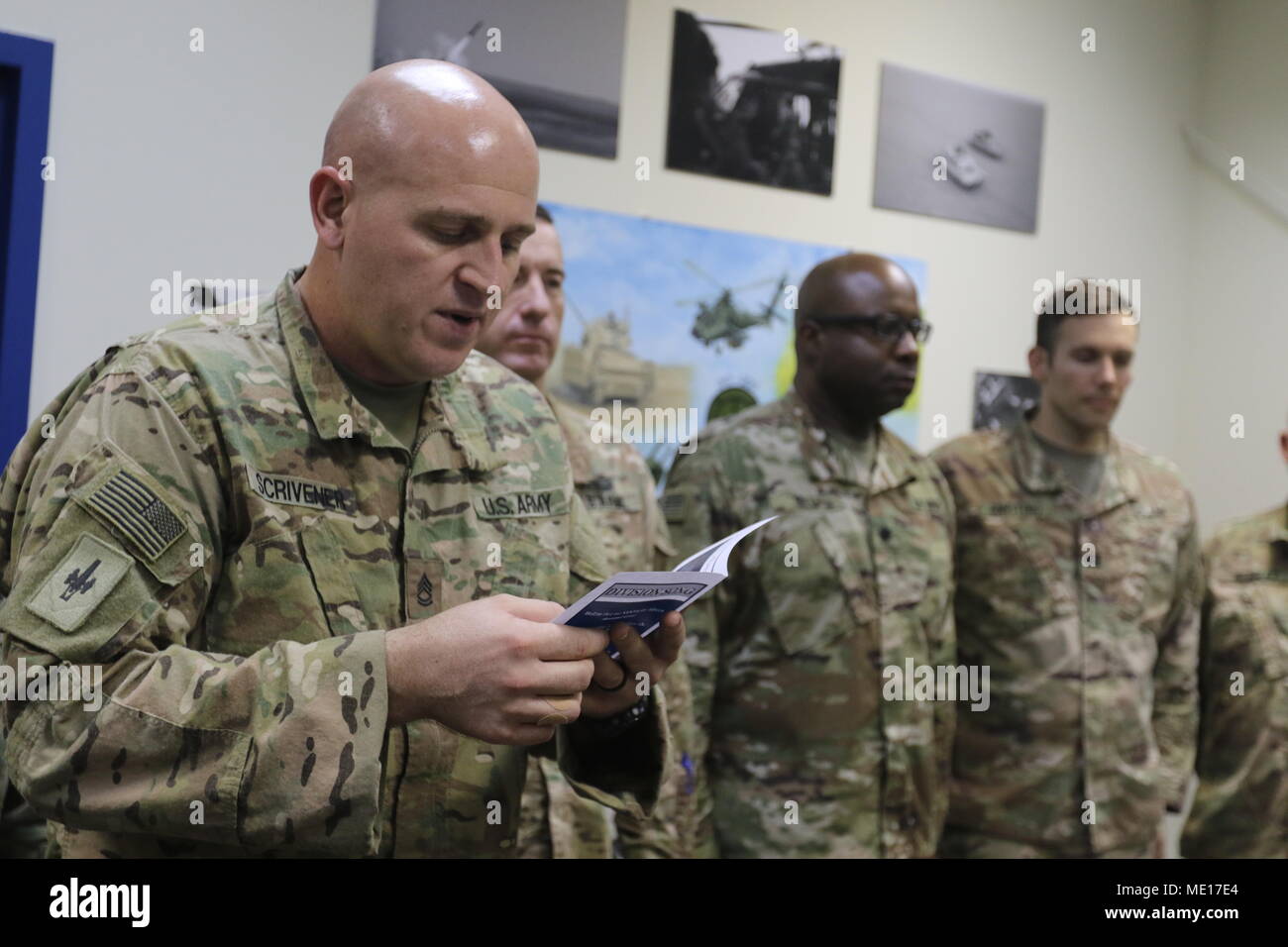 CAMP ARIFJAN, Kuwait – Sgt. First Class Kristopher Scrivener, 35th Infantry Division, reads Staff Sgt. James Ira “Junior” Spurrier’s official Medal of Honor citation at the dedication of the Spurrier Conference Room at the 35th Inf. Div.’s forward deployed headquarters building Dec. 22, 2017. (U.S. Army photo by Master Sgt. Mark Hanson) Stock Photo