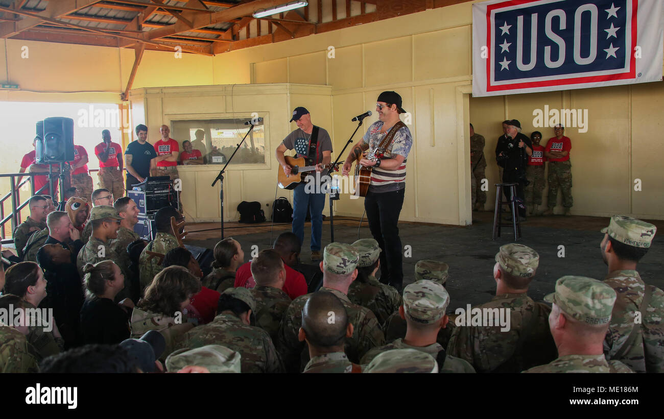 Country Singer Jerrod Niemann performs for the coaltion forces during the USO Holiday Tour 2017, at Camp Taji, Iraq, Dec. 25, 2017. Camp Taji is one of four Combined Joint Task Force – Operation Inherent Resolve building partner capacity locations dedicated to training partner forces and enhancing their effectiveness on the battlefield. (U.S. Army photo by Spc. Antonio Lewis) Stock Photo