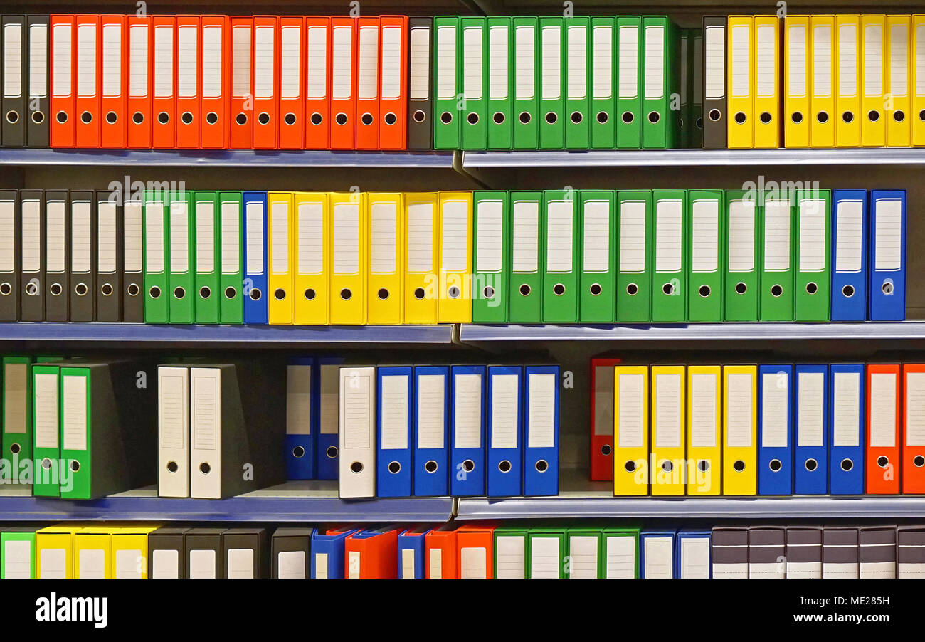 Shelf with colourful ring binders Stock Photo Alamy