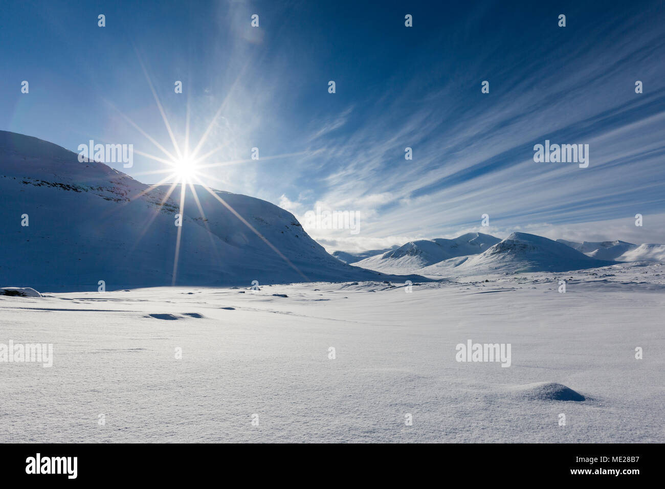 Sun over mountain range in the snow, Kungsleden or king's trail, Province of Lapland, Sweden, Scandinavia Stock Photo