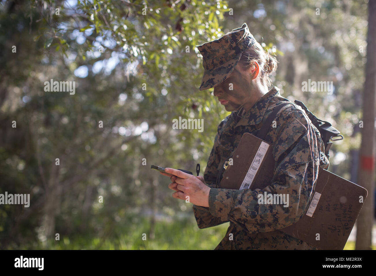 U.S. Marine Corps Rct. Kaylynn K. Kalama with Platoon 4001, Oscar Company, 4th Recruit Training Battalion, prepares to enter the land navigation course Dec. 14, 2017, on Parris Island, S.C. Recruits, like Kalama, 18, from Hamilton, Ohio, learn how to traverse unfamiliar territory using a map and compass during Basic Warrior Training. Oscar Company graduated Jan. 5, 2018. Parris Island has been the site of Marine Corps recruit training since Nov. 1, 1915. Today, approximately 19,000 recruits come to Parris Island annually for the chance to become United States Marines by enduring 12 weeks of ri Stock Photo