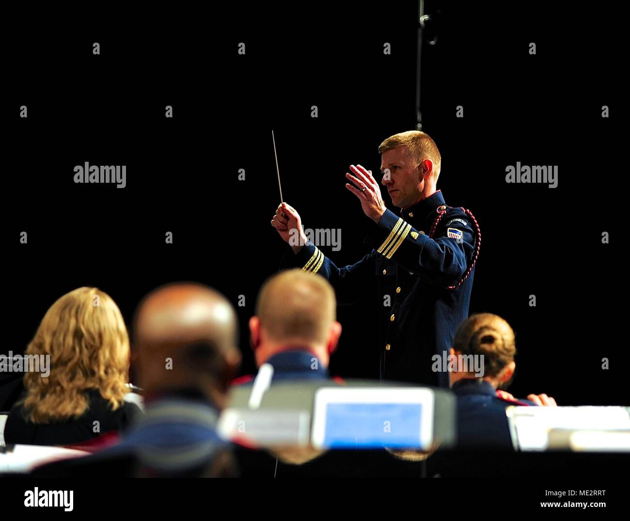 Lt. Cmdr. Adam Williamson conducts the Coast Guard Band during a