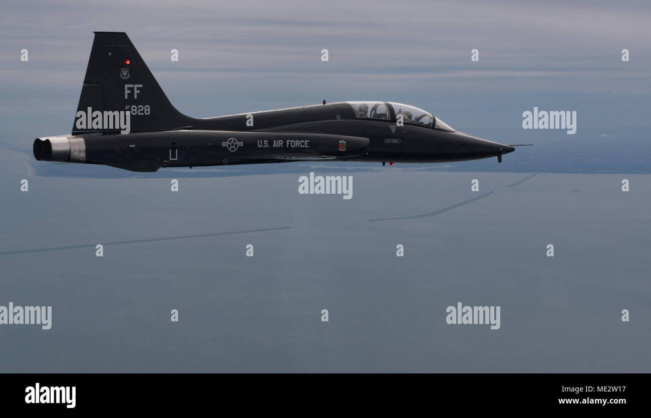A T-38 Talon from the 71st Fighter Training Squadron flies over the Chesapeake Bay Bridge Tunnel, Va. after participating in a RED AIR mission, Dec. 7, 2017. The 71st FTS, also referred to as the “Ironmen”, is one of three flying squadrons assigned to the 1st Fighter Wing at Joint Base Langley-Eustis, Va..(U.S. Air Force Photo by Staff Sgt. Carlin Leslie) Stock Photo