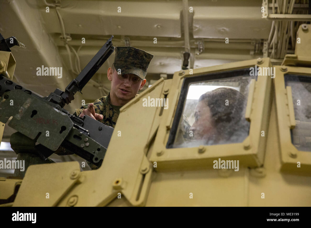 Cpl. Christopher P. Burns-Marino (left) explains the function and operation of the M2 .50-caliber Browning machine gun during tours of the future USS Portland (LPD 27) in Portland, Oregon, April 18, 2018. Portland is the U.S. Navy’s 11th San Antonio-class amphibious transport dock ship. It is the third ship to bear the name USS Portland, However it is the first ship to be named solely for Oregon’s largest city. Burns-Marino, from Boston, Massachussetts, is a motor vehicle operator with Truck Company, Headquarters Battalion, 1st Marine Division, I Marine Expeditionary Force. (U.S. Marine Corps  Stock Photo