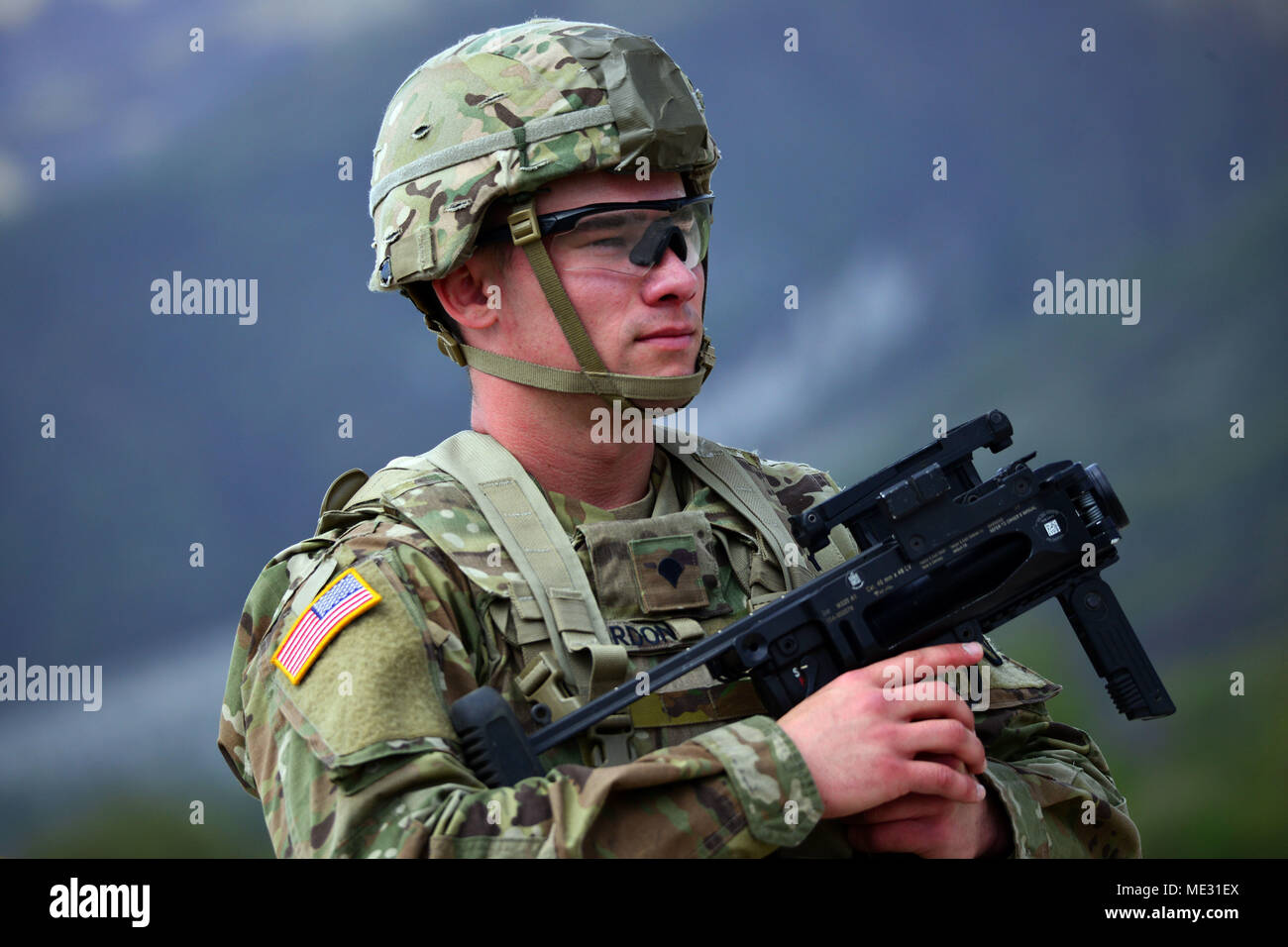 U.S. Army Paratrooper assigned to the Battalion Support Brigade, 173rd Airborne Brigade observe area with his M320 grenade launcher module during weapons qualification at Cao Malnisio Range, Pordenone, Italy, April 17, 2018. The 173rd Airborne Brigade is the U.S. Army Contingency Response Force in Europe, capable of projecting ready forces anywhere in the U.S. European, Africa or Central Commands' areas of responsibility. (U.S. Army Photos by Paolo Bovo) Stock Photo
