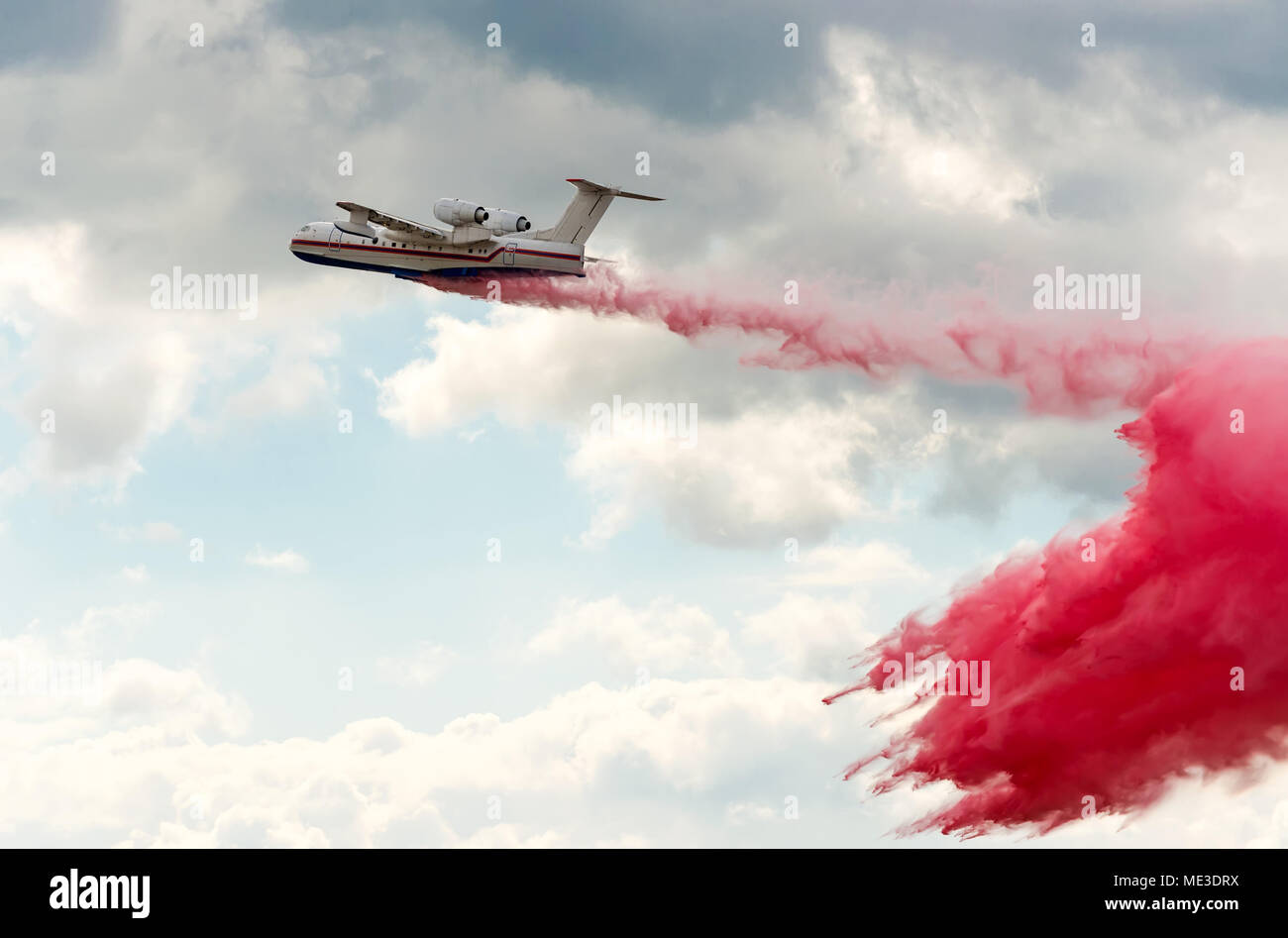 Flying aerial firefighting pour water over the fire Stock Photo Alamy