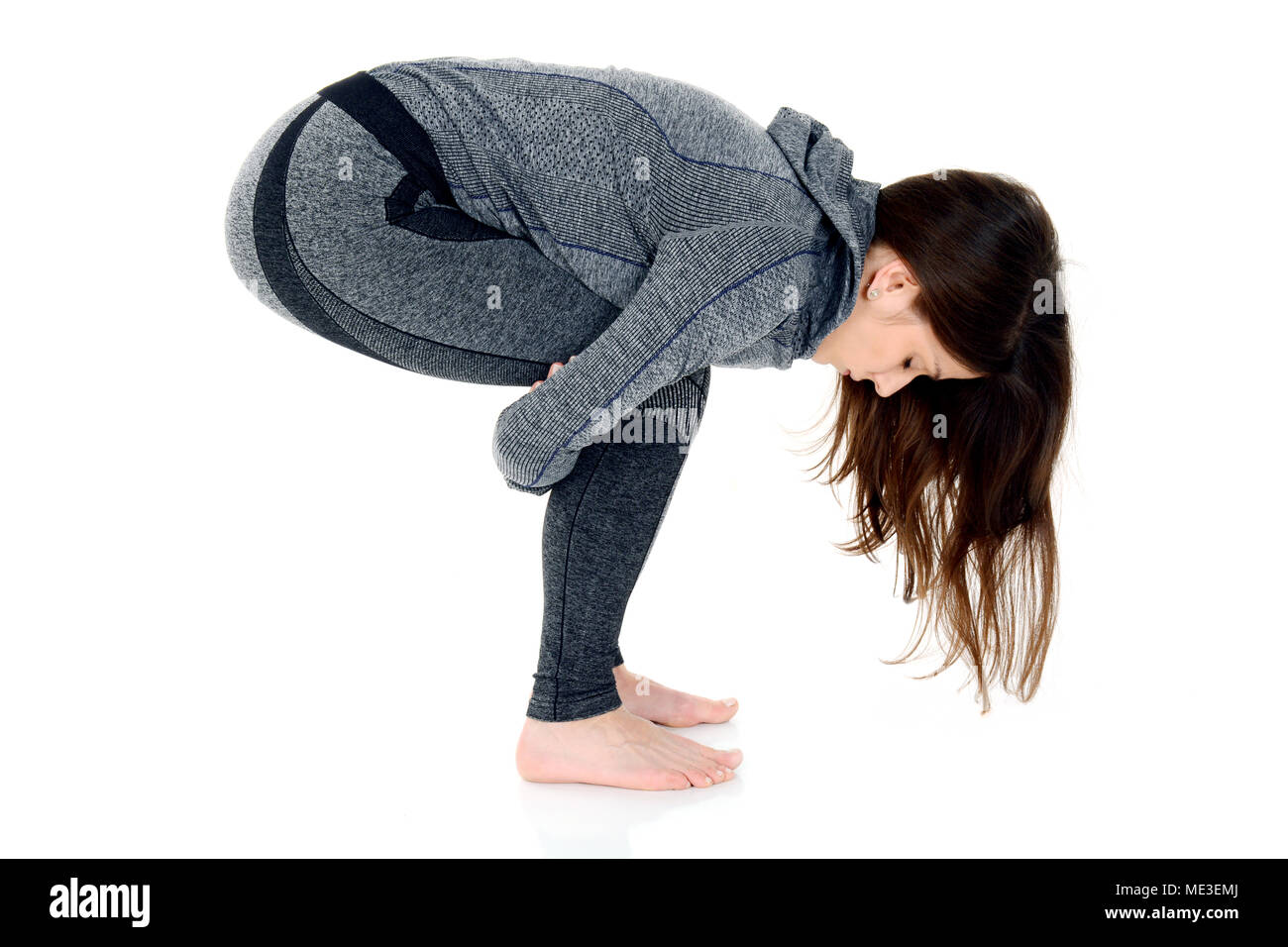 Young woman doing yoga isolated on white Stock Photo - Alamy