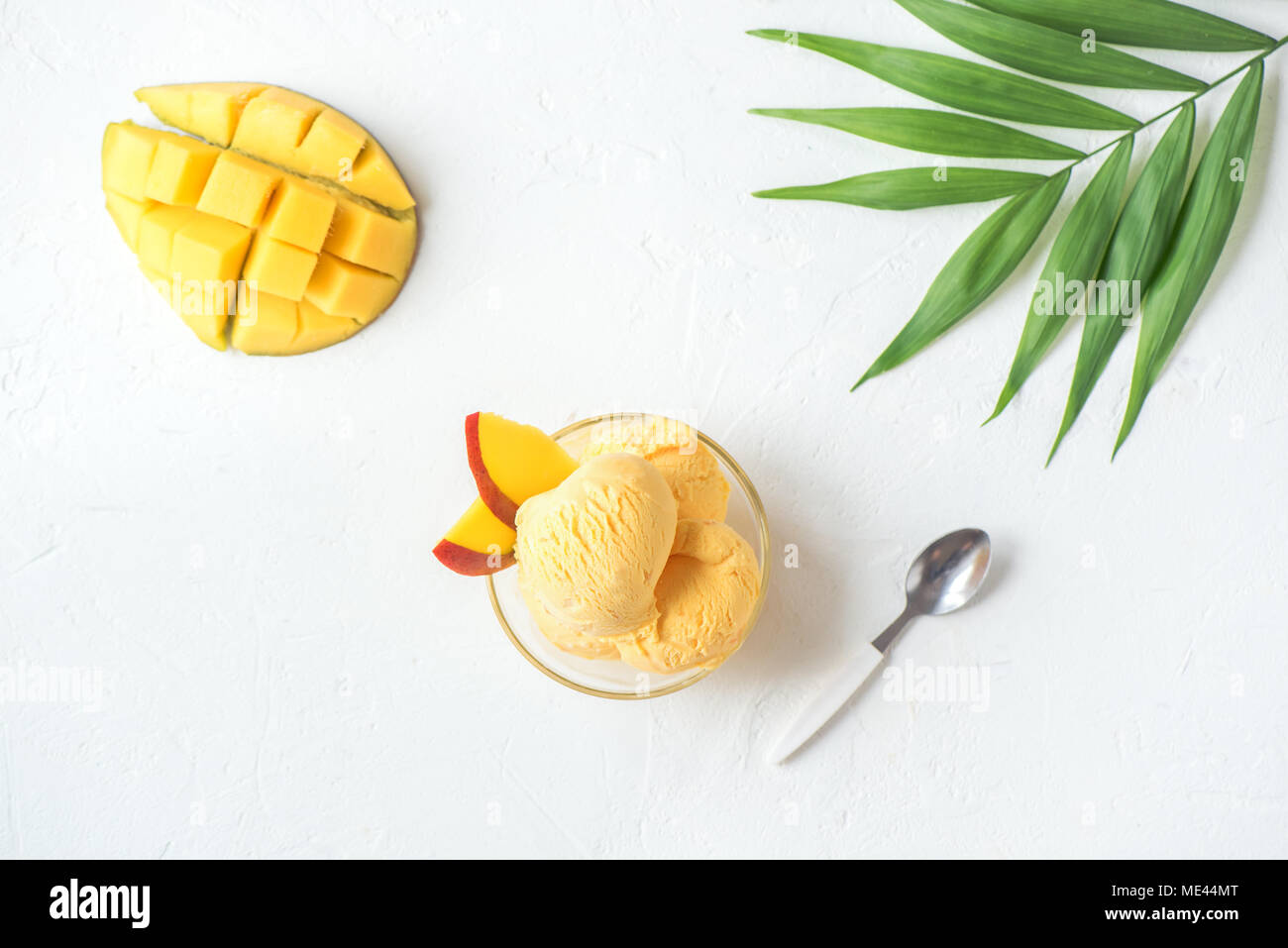 Mango Ice Cream or Sorbet in bowl. Homemade fruit mango ice cream on white background, copy space. Stock Photo