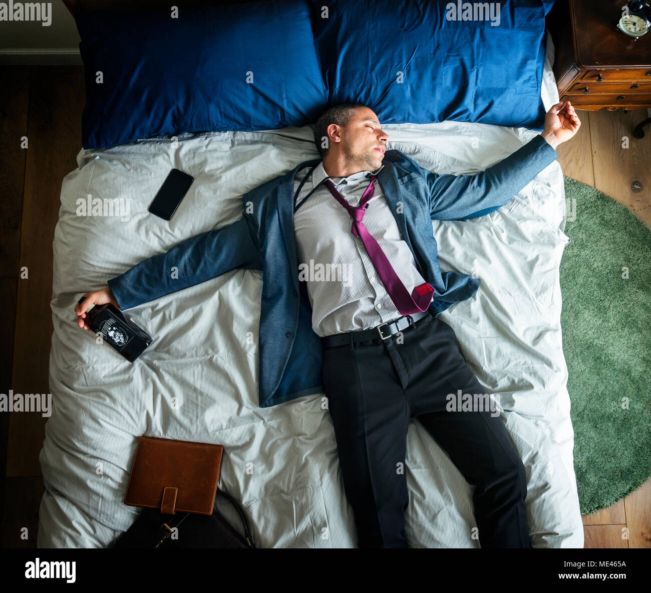 Drunk business man falling asleep as soon as he came back home Stock Photo