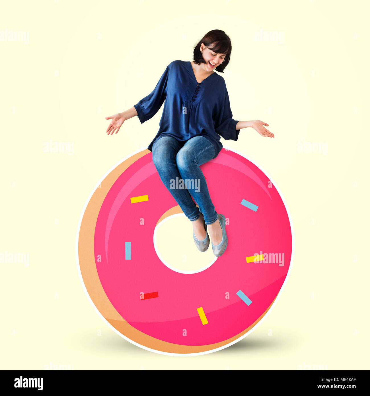 Woman sitting on a doughnut Stock Photo