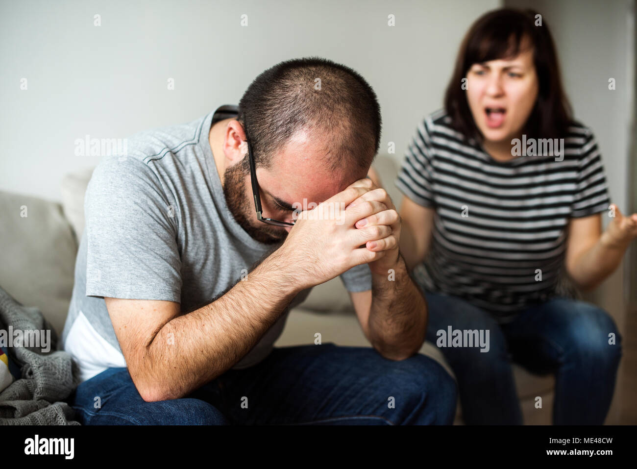 Unhappy couple arguing on the sofa Stock Photo
