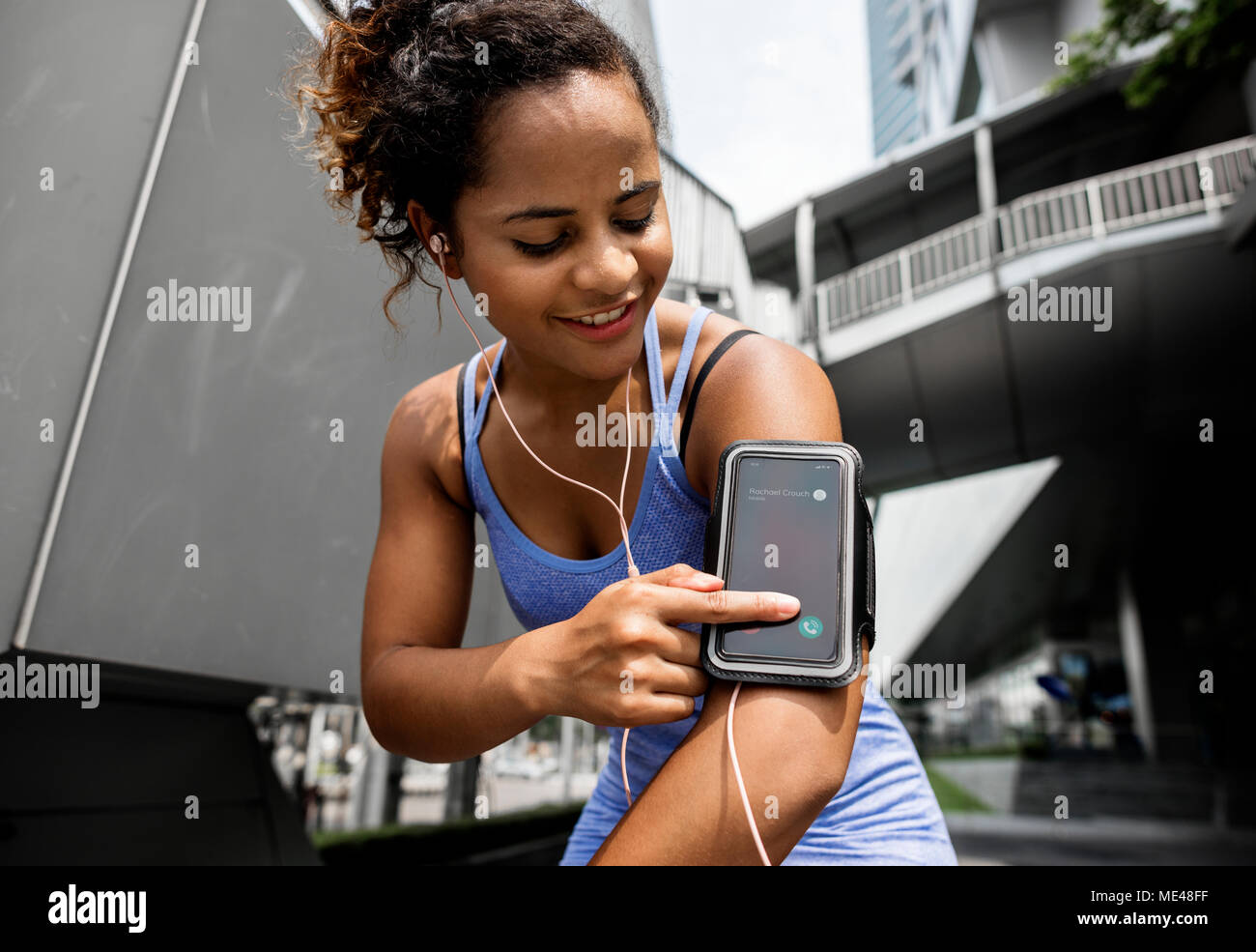 Healthy woman exercising while using technology Stock Photo