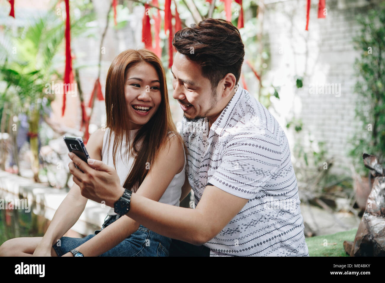 Young couple using a phone together Stock Photo