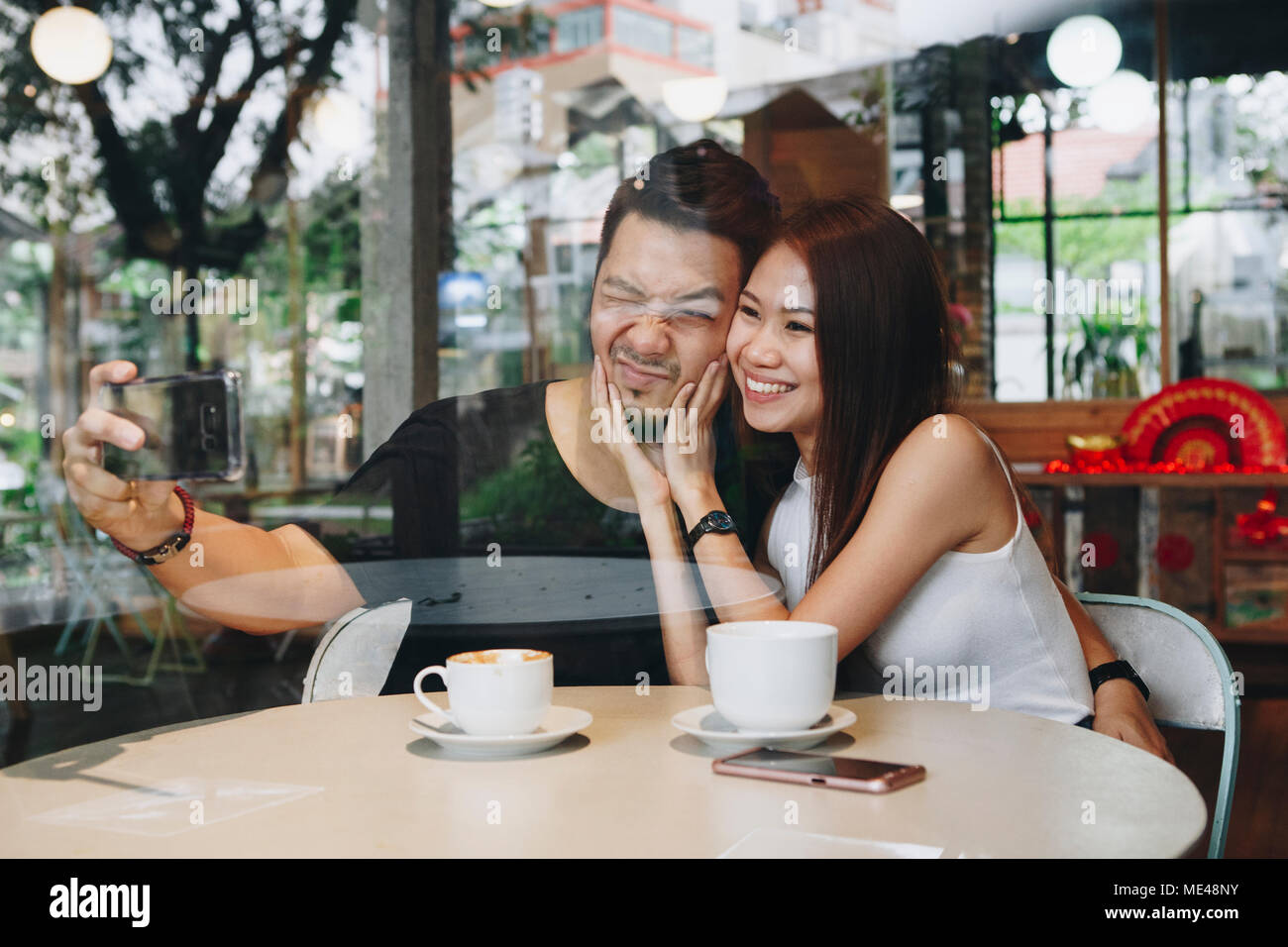 Lovely asian couple having coffee Stock Photo