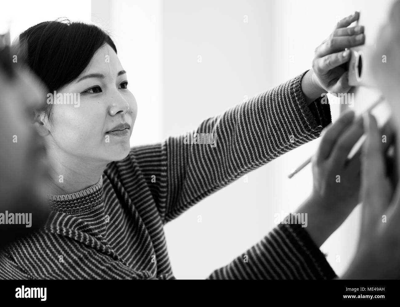 Asian couple measuring the wall Stock Photo