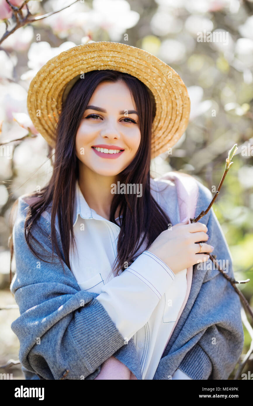 Summer portrait of pretty woman posing on amazing blooming tree ...