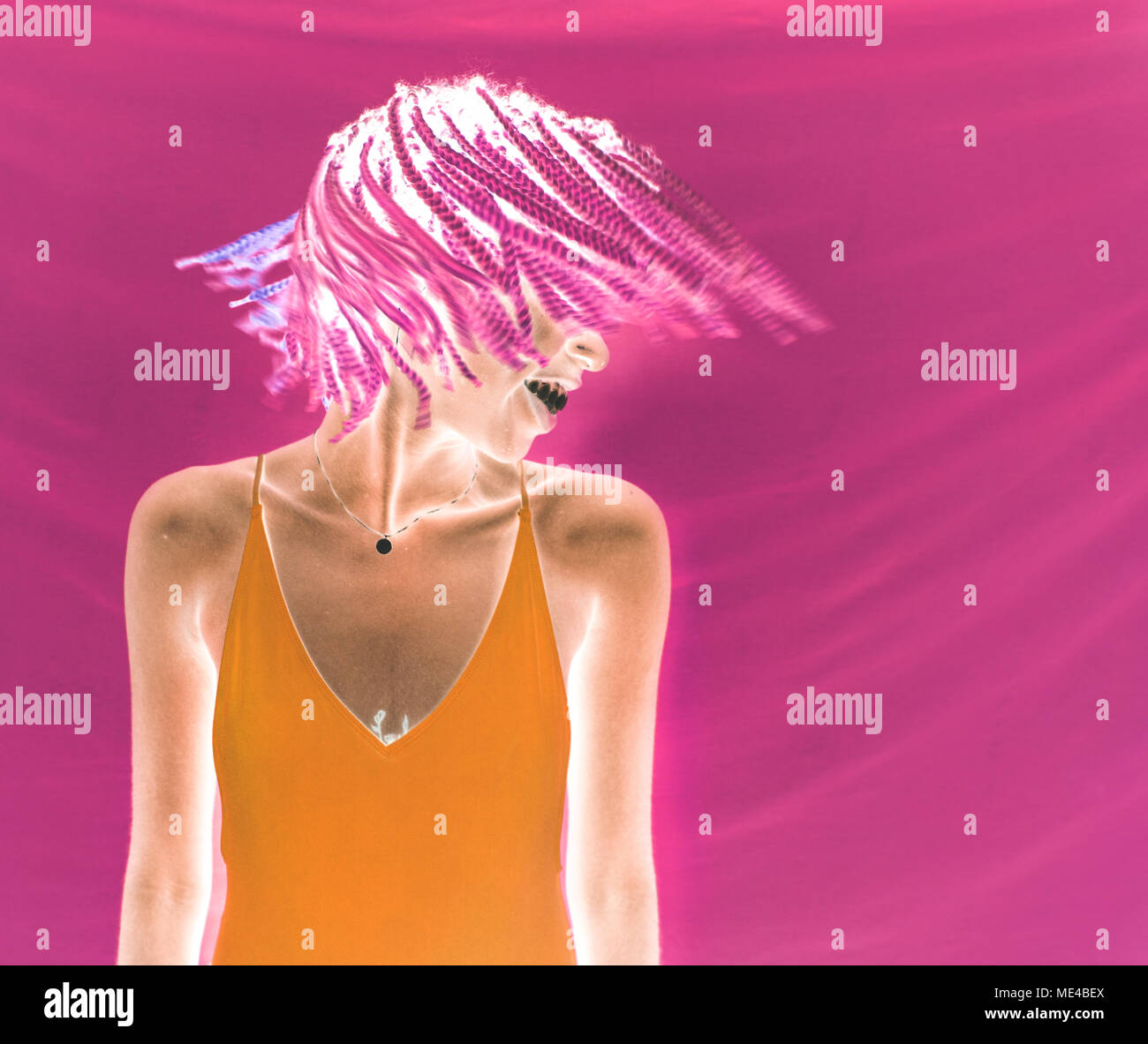 Girl shaking her pink braided hair Stock Photo