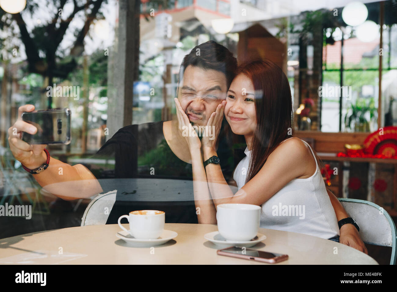 Lovely asian couple having coffee Stock Photo