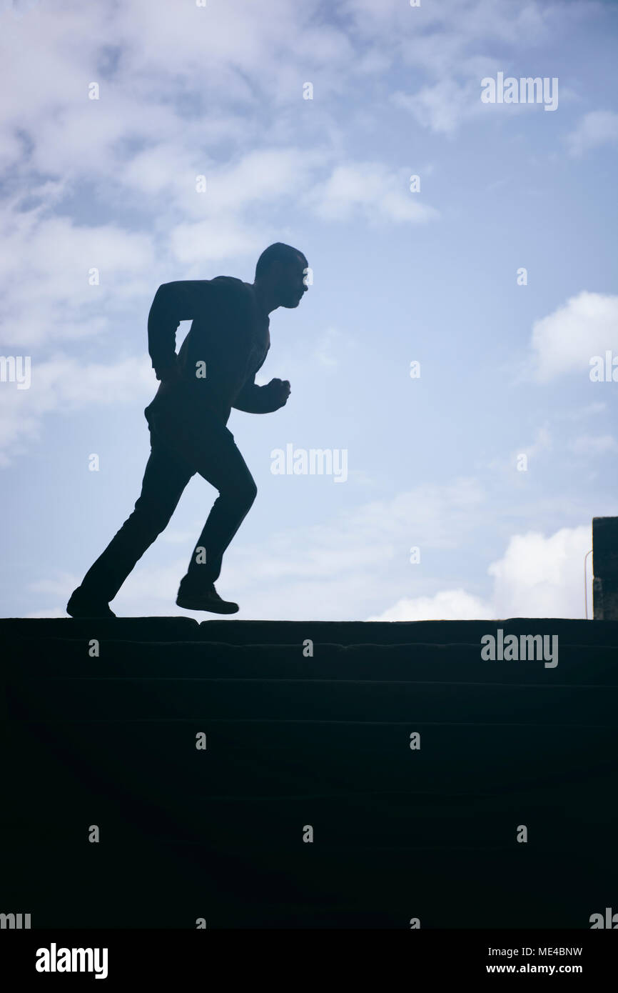 Side view silhouette of a man running outdoors Stock Photo
