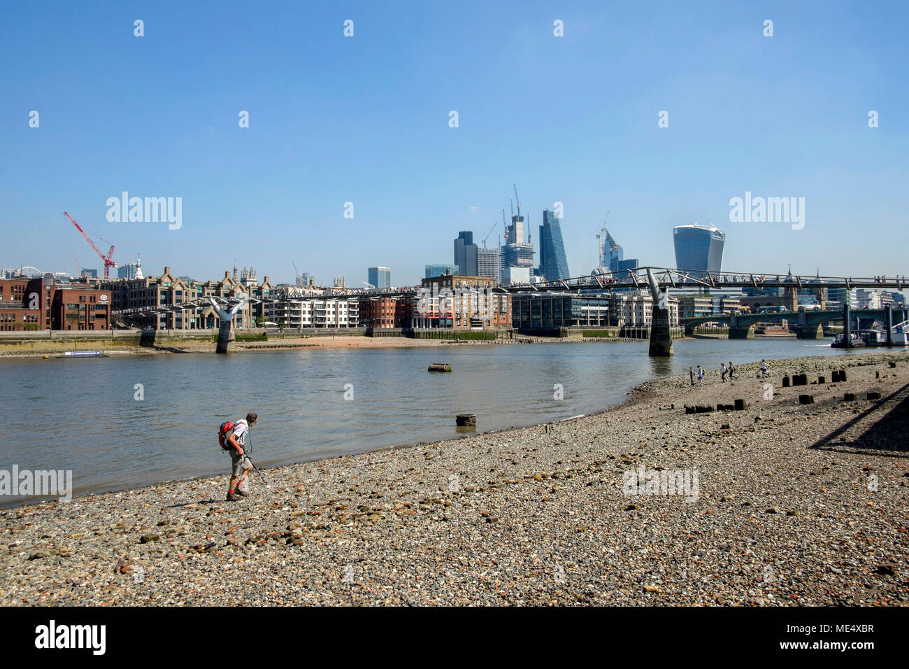 River Thames foreshore at low tide with view towards the City of London. Stock Photo