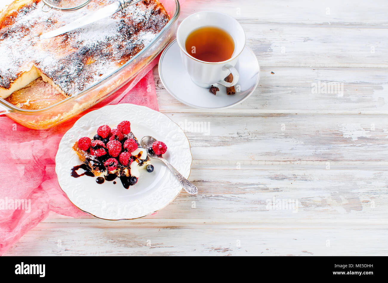Portion cottage cheese casserole with  tea on a wooden table. health or diet concept.selective focus Stock Photo