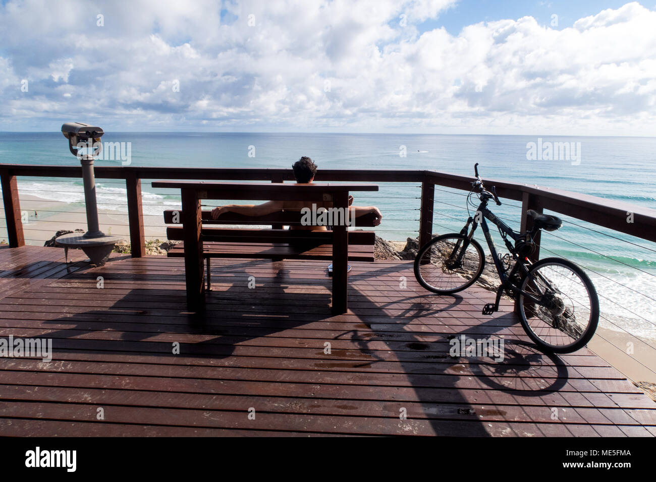 Man gazing out to the Pacific Ocean on the Gold Coast in Queensland Australia Stock Photo