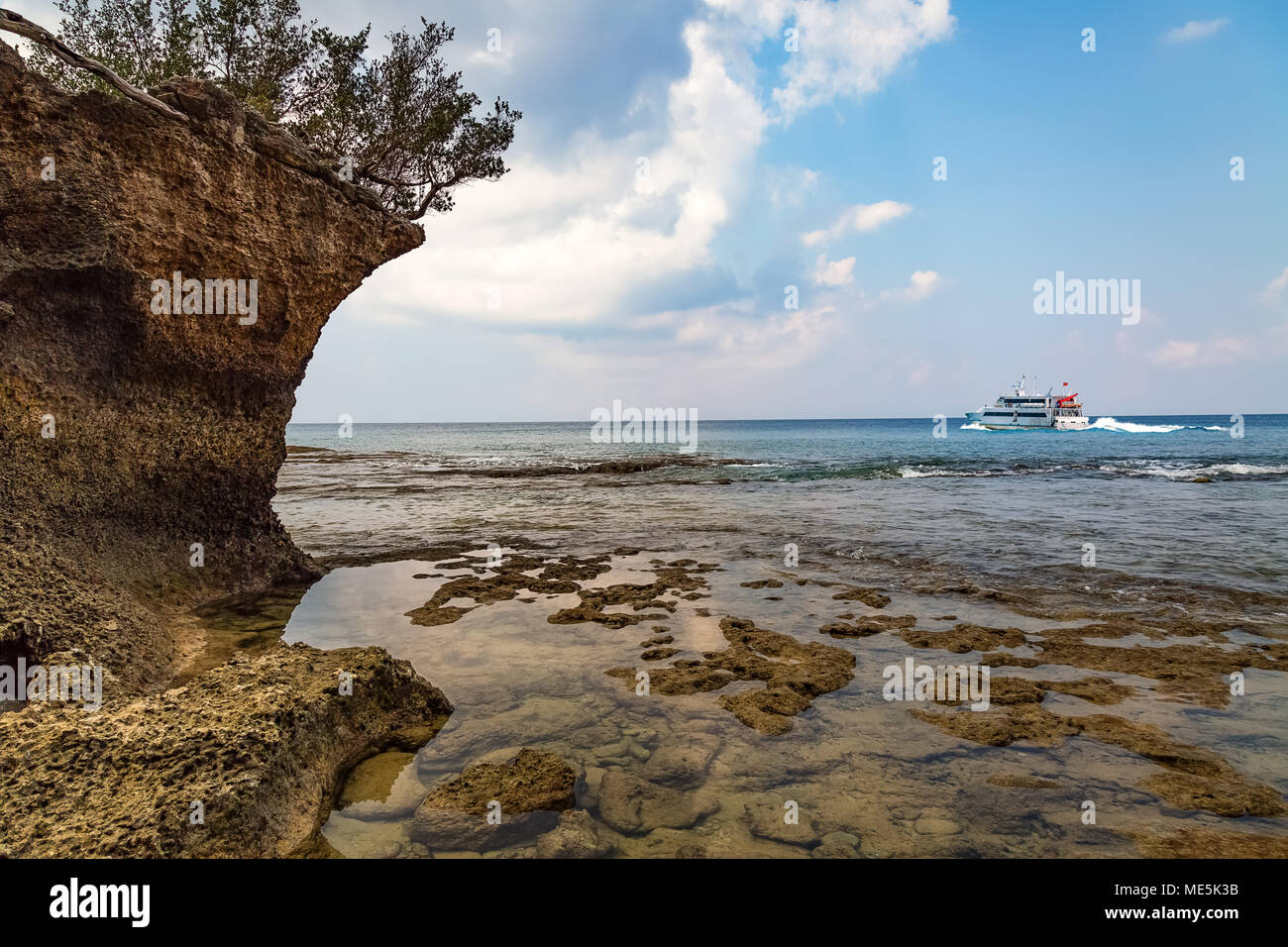 Scenic Neil Island sea beach Andaman with corals and natural rock formations and view of a cruise ship at the horizon. Stock Photo